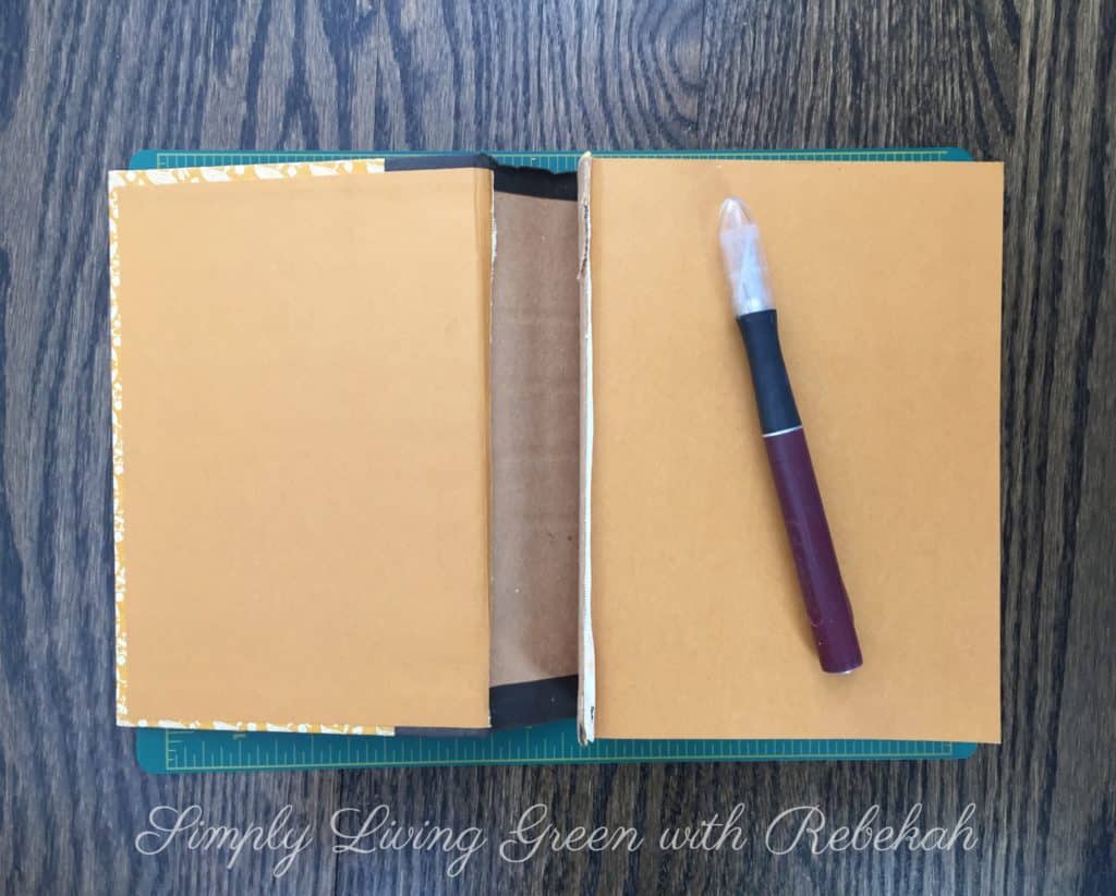 Carefully cut the spine and book pages from the front and back cover using the Exacto knife, metal straight edge and cutting mat. 
