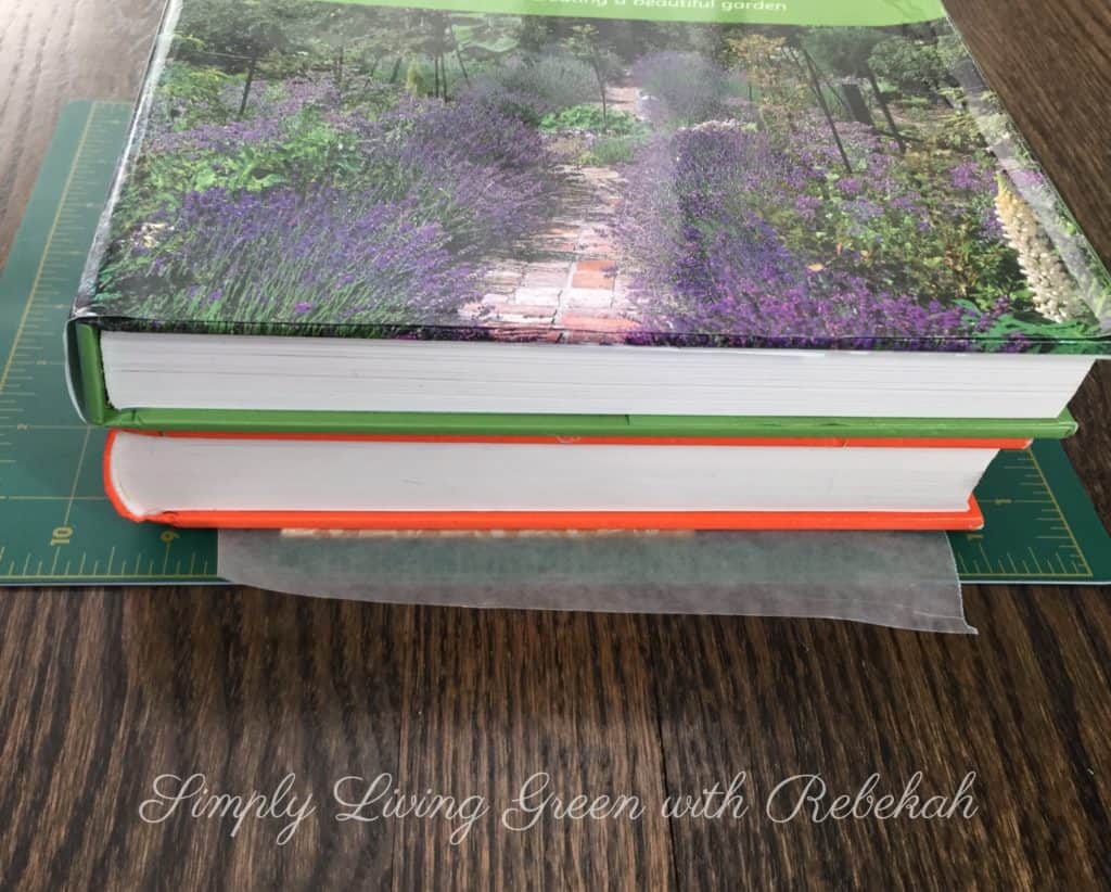 I recommend placing a piece of wax paper on top of the cover, and then stacking a couple books on top and let it dry for an hour to ensure a good bond.  