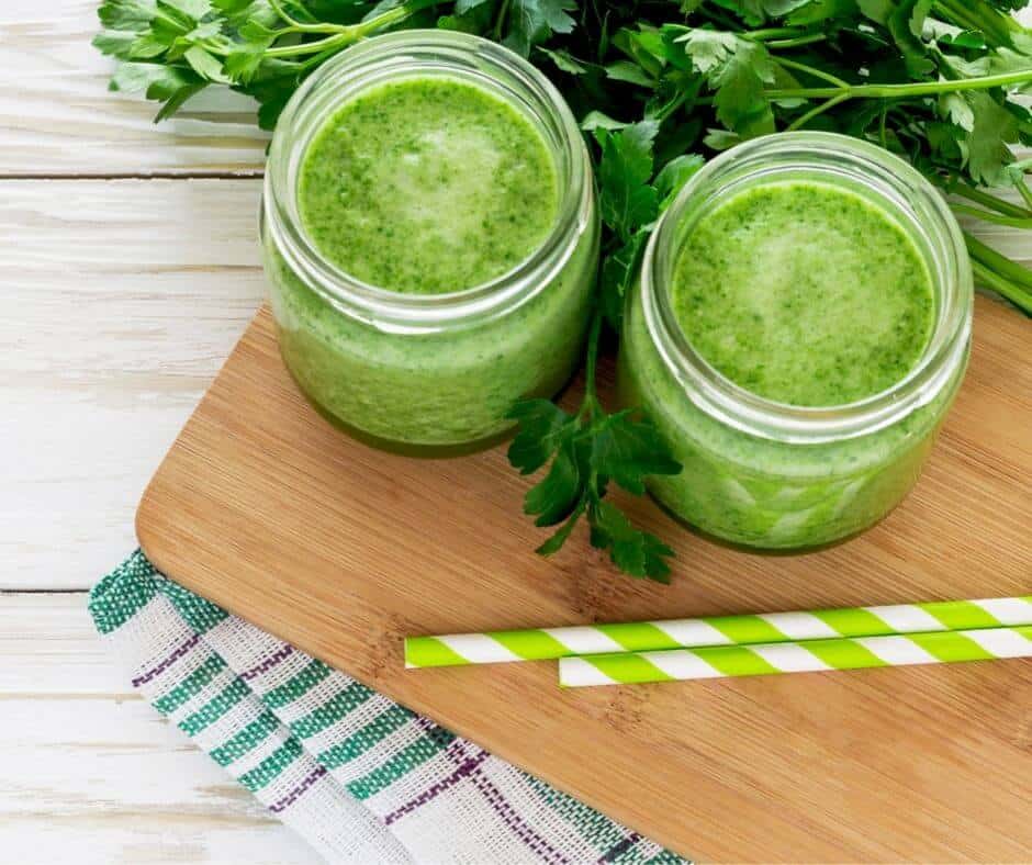 two green smoothies with paper straws