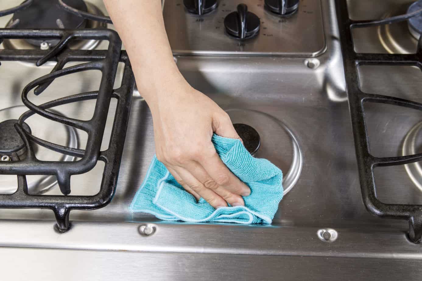 wiping down stove top with microfiber