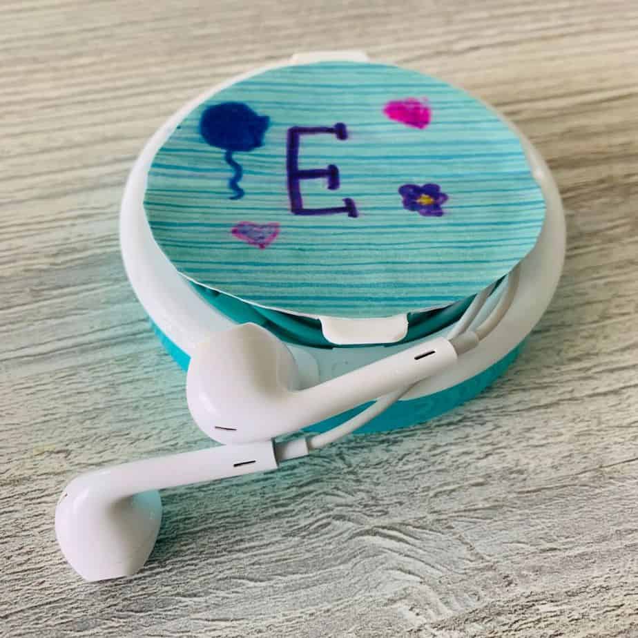 upcycled earbuds case made from a plastic mint container
